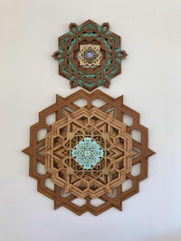 two wooden mandalas hanging on a wall